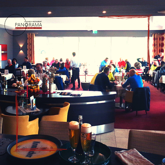 Belebte Lounge im PANORAMA mit Gästen und kühlem Bier